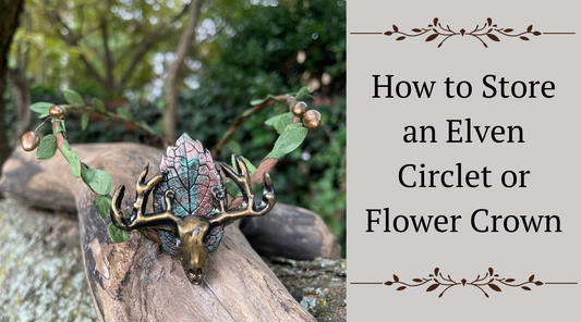 A photo of a circlet with an elk motif with green vines and gold buds sitting on a tree branch.