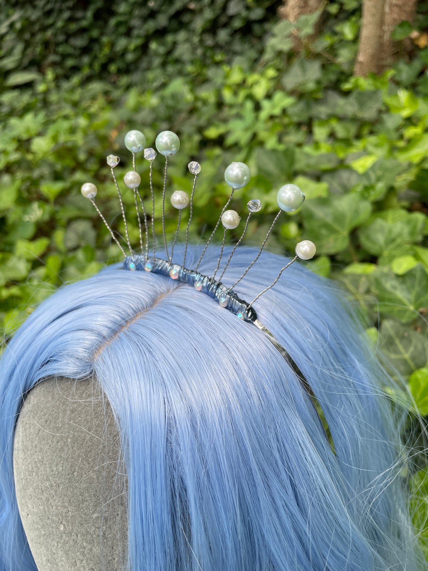 Blue celestial tiara crown on a model with blue hair in a garden setting