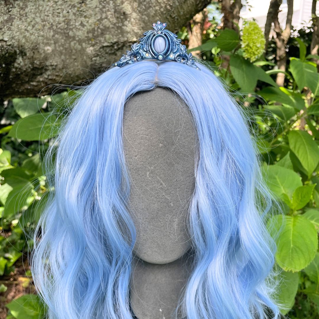 Silver mermaid tiara on a model with blue hair in a garden setting