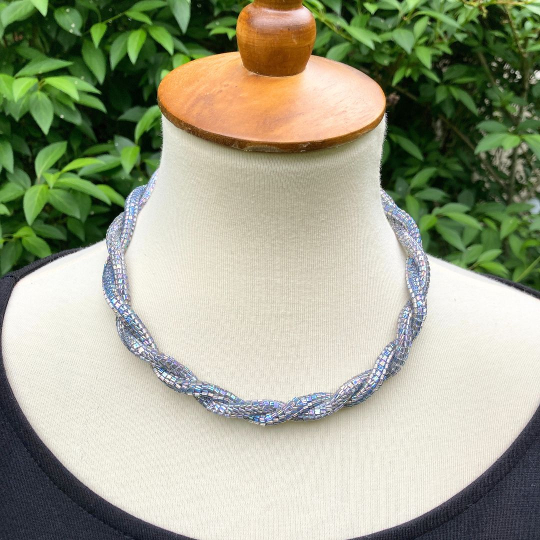 Beaded rope necklace on a model in a garden setting