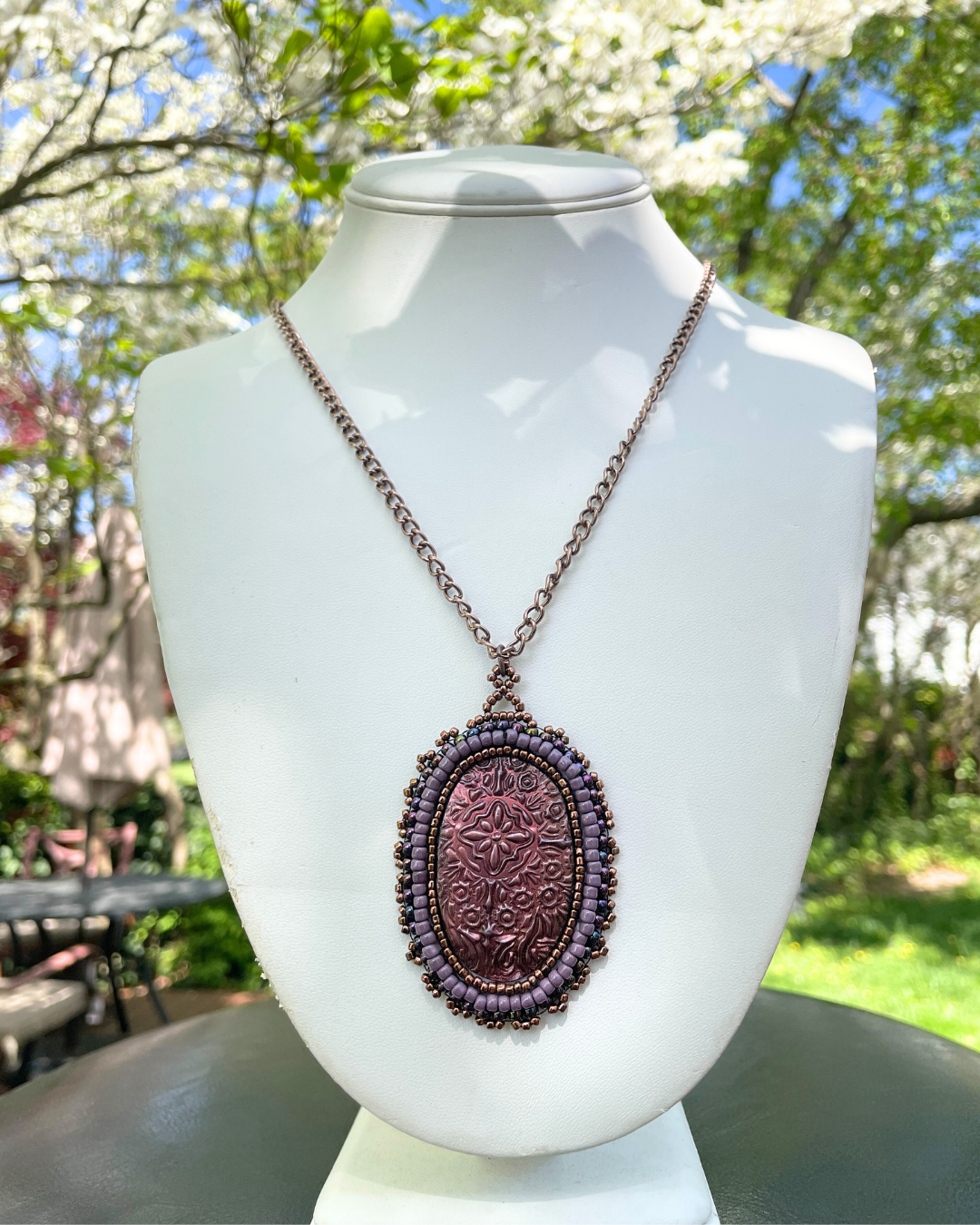 pink floral medieval necklace in garden setting