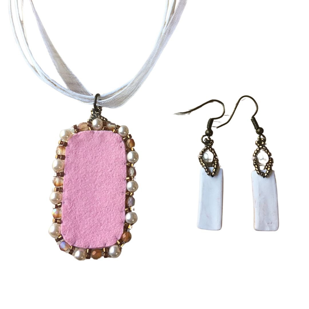Back of copper and white floral beaded necklace jewelry set against a white background.