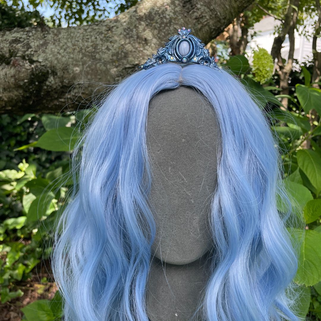 Blue mermaid tiara on a model with blue hair in a garden setting