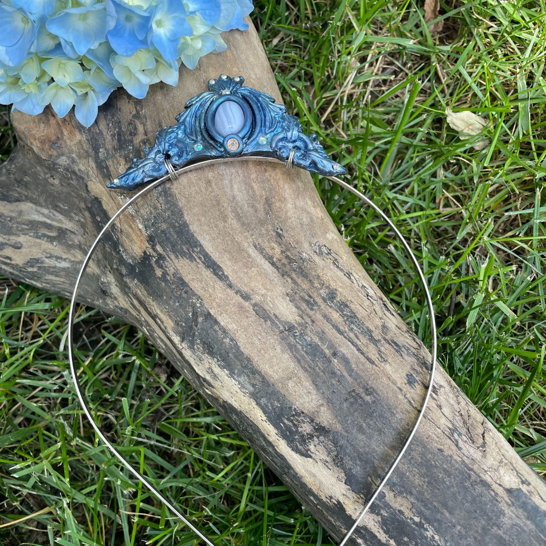 Blue mermaid tiara on a log in a garden