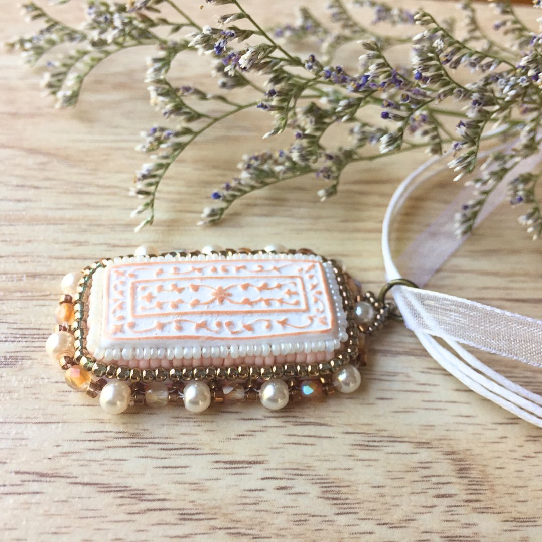 Side profile of Back of copper and white floral beaded necklace jewelry set against a white background.