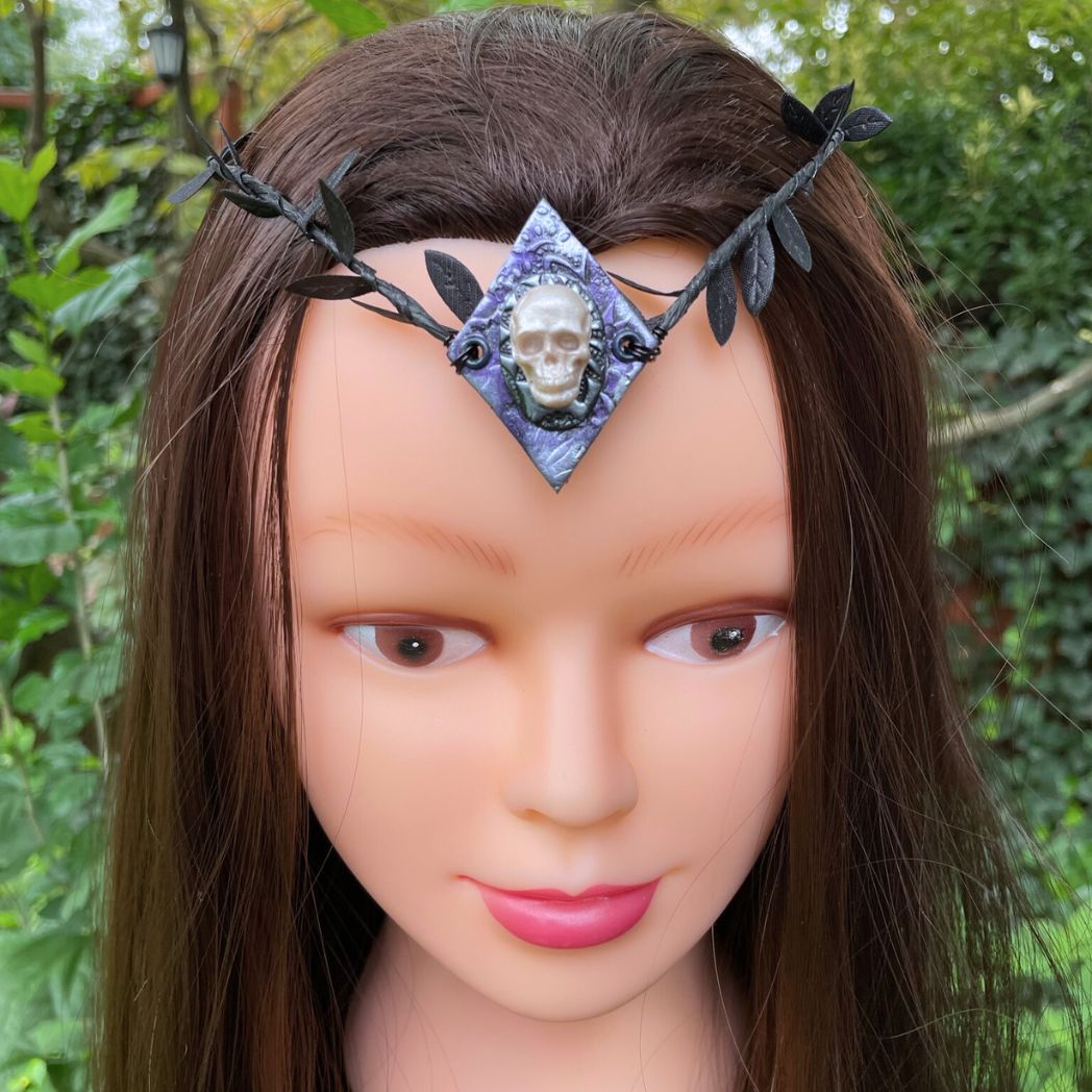 Skull black leaf wire crown resting on a model.