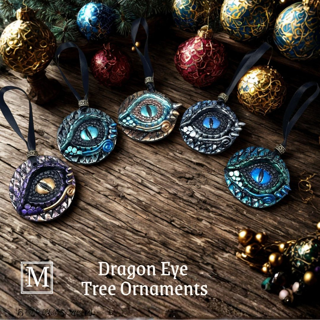 5 dragon eye ornaments in a semi circle on wood surface with baubles surrounding them.
