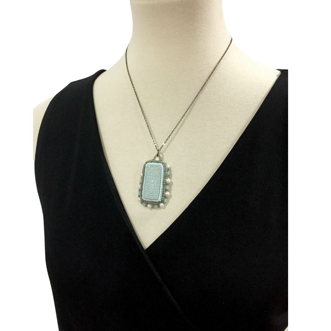 duck egg blue floral beaded necklace jewelry set on model against a white background.