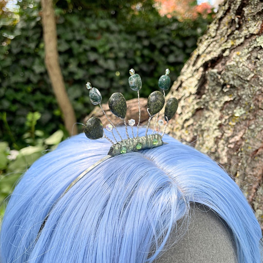 Side profile of forest nymph headband tiara on model with a blue wig in a forest setting.