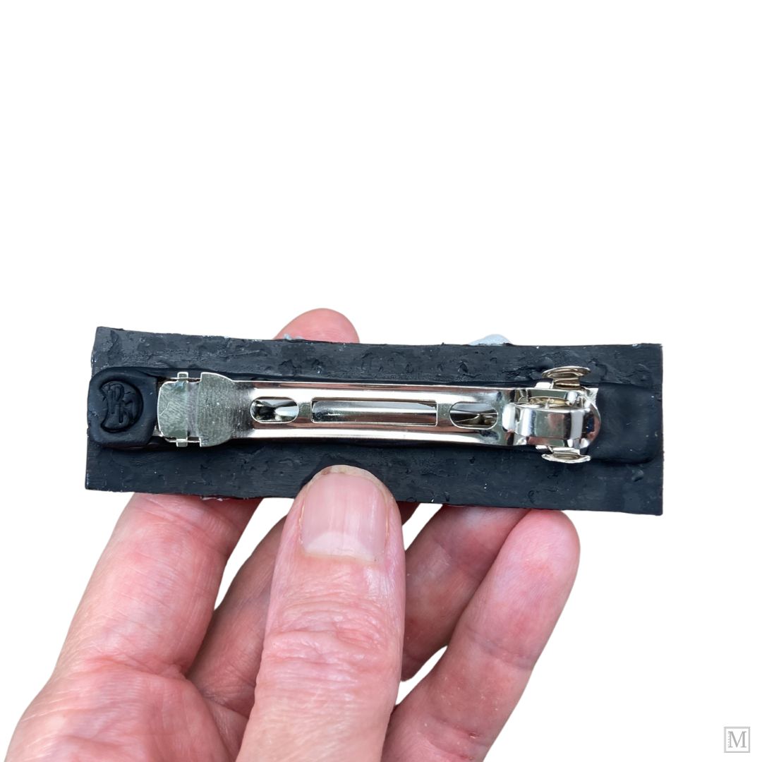 Back of french barrette hair clip held in hand