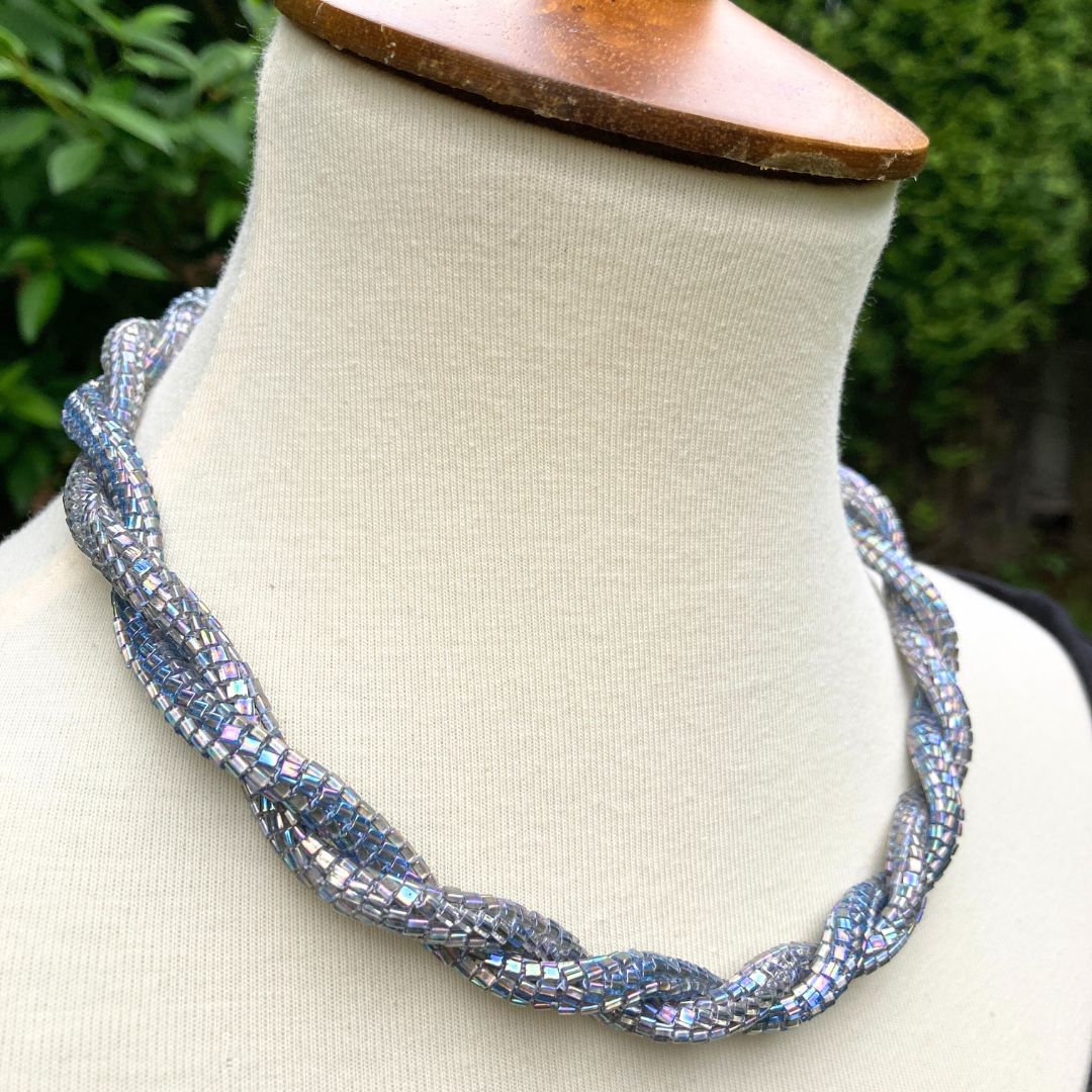 Side profile of Beaded rope necklace on a model in a garden setting