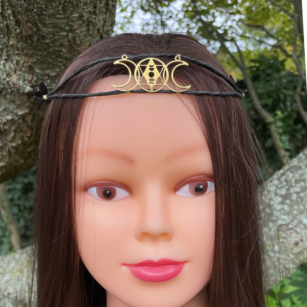 Gold triple moon motif crown on model