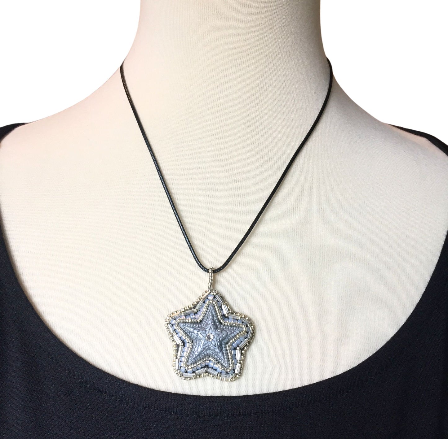 model wearing silver beaded star necklace