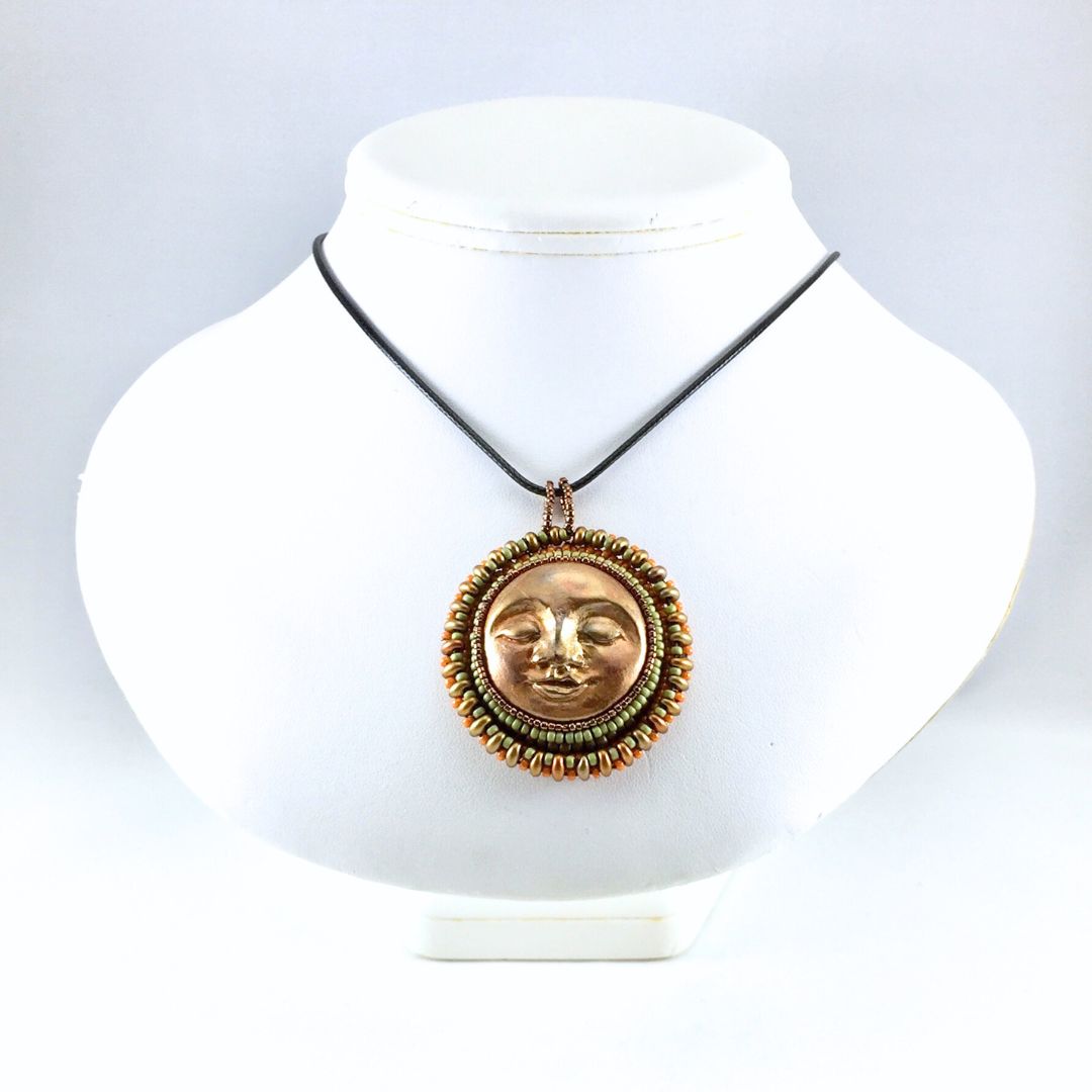 sun pendant on display bust