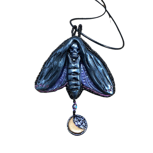 Silver and purple Death Head Moth pendant made with black polymer clay with a round charm with a crescent moon.