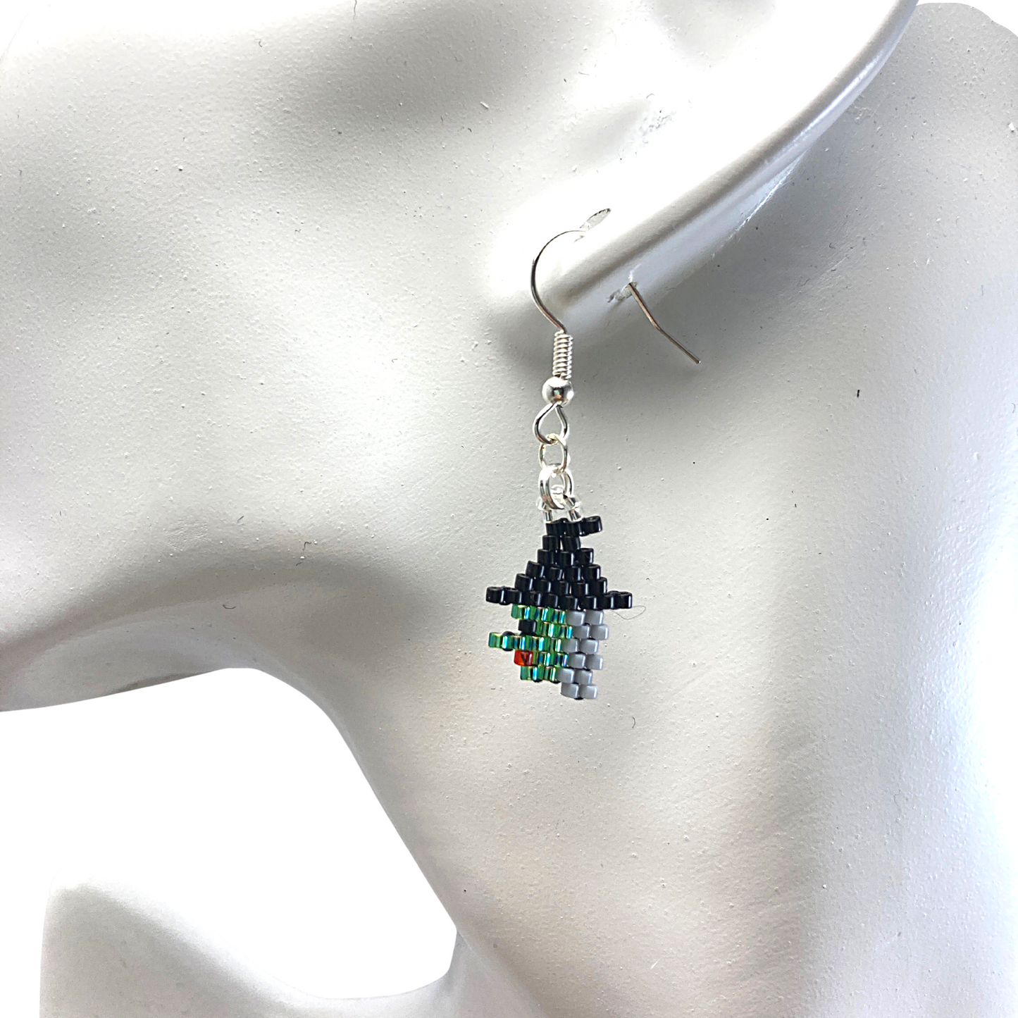 Side profile green witch beaded earrings on model