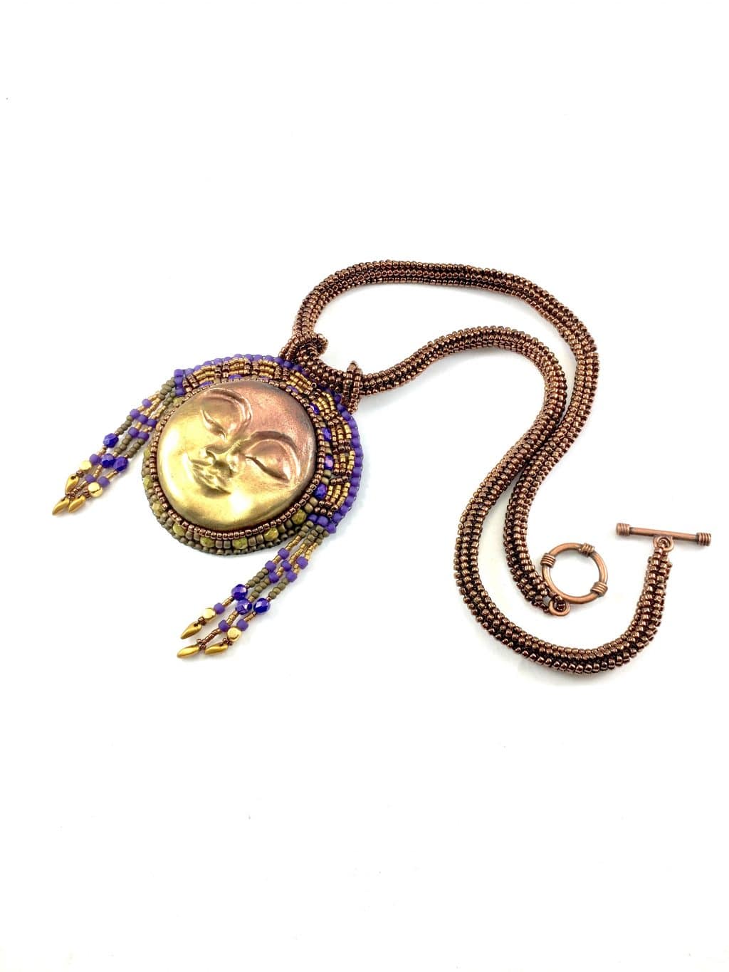 Flat lay view of the Egyptian sun goddess statement beaded gold art necklace with beaded headdress.