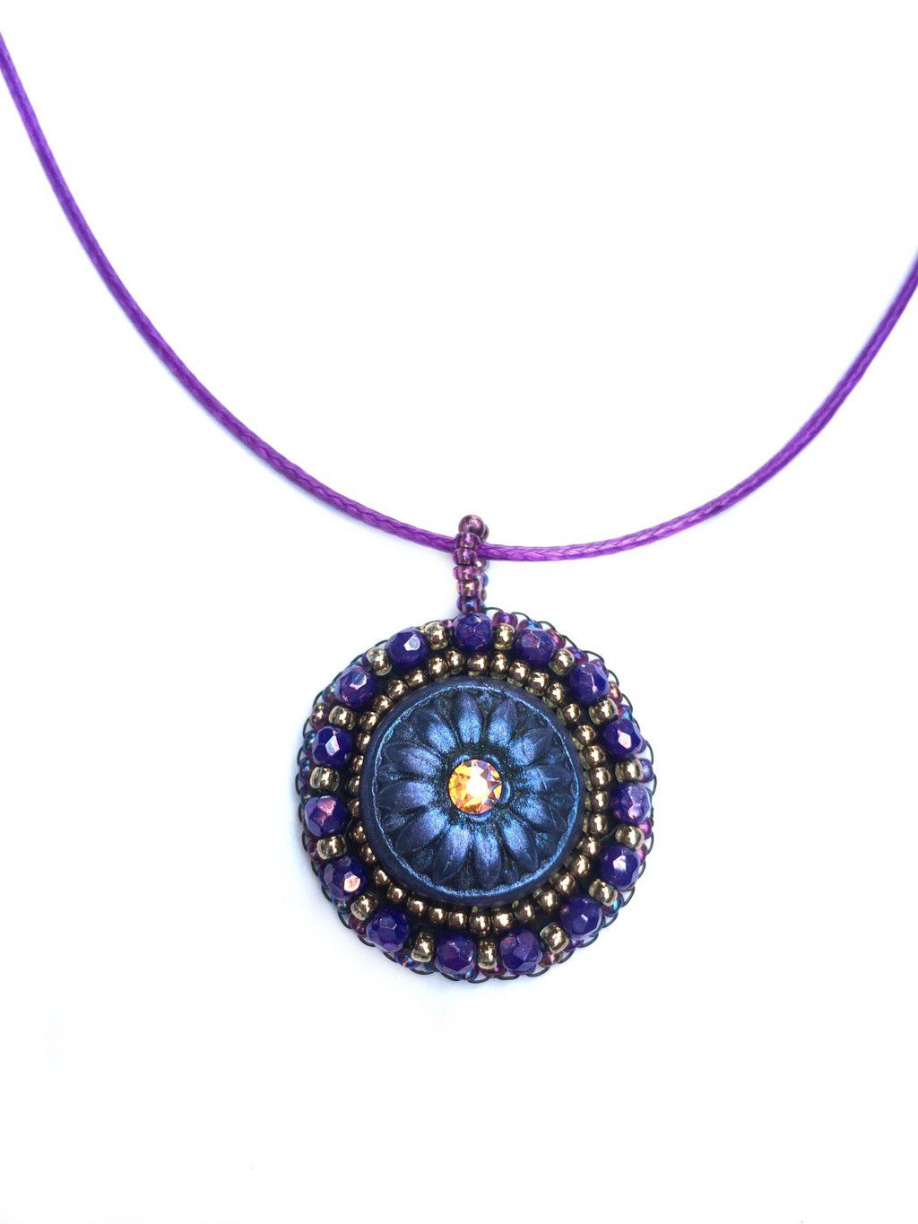 purple and blue daisy pendant with crystal center and purple beaded edging on a purple cord