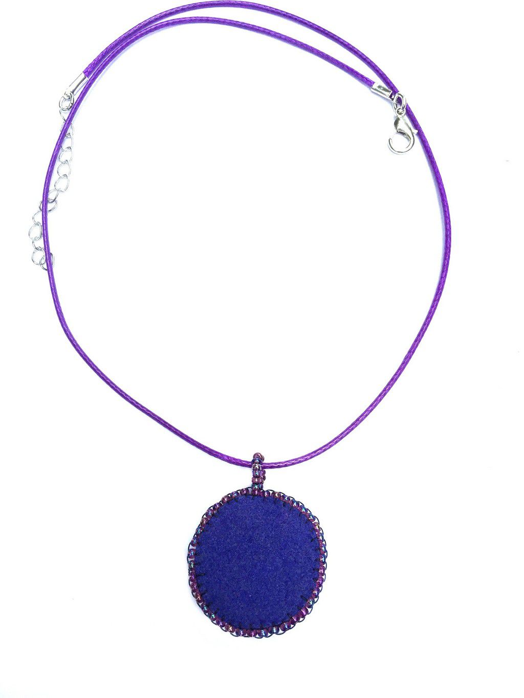 Back of purple and blue daisy pendant with crystal center