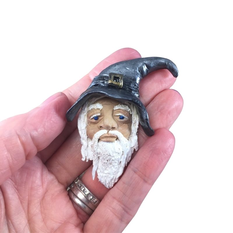 A gray hat wizard brooch