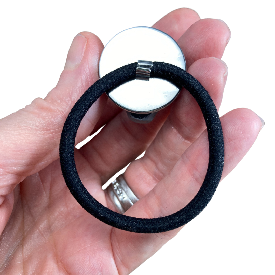 Back of an alien hair tie showing the hair elastic