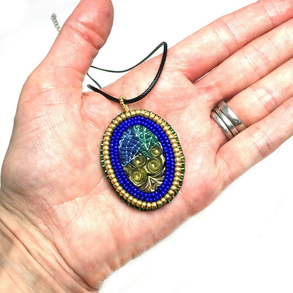 zentangle pattern pendant in hand