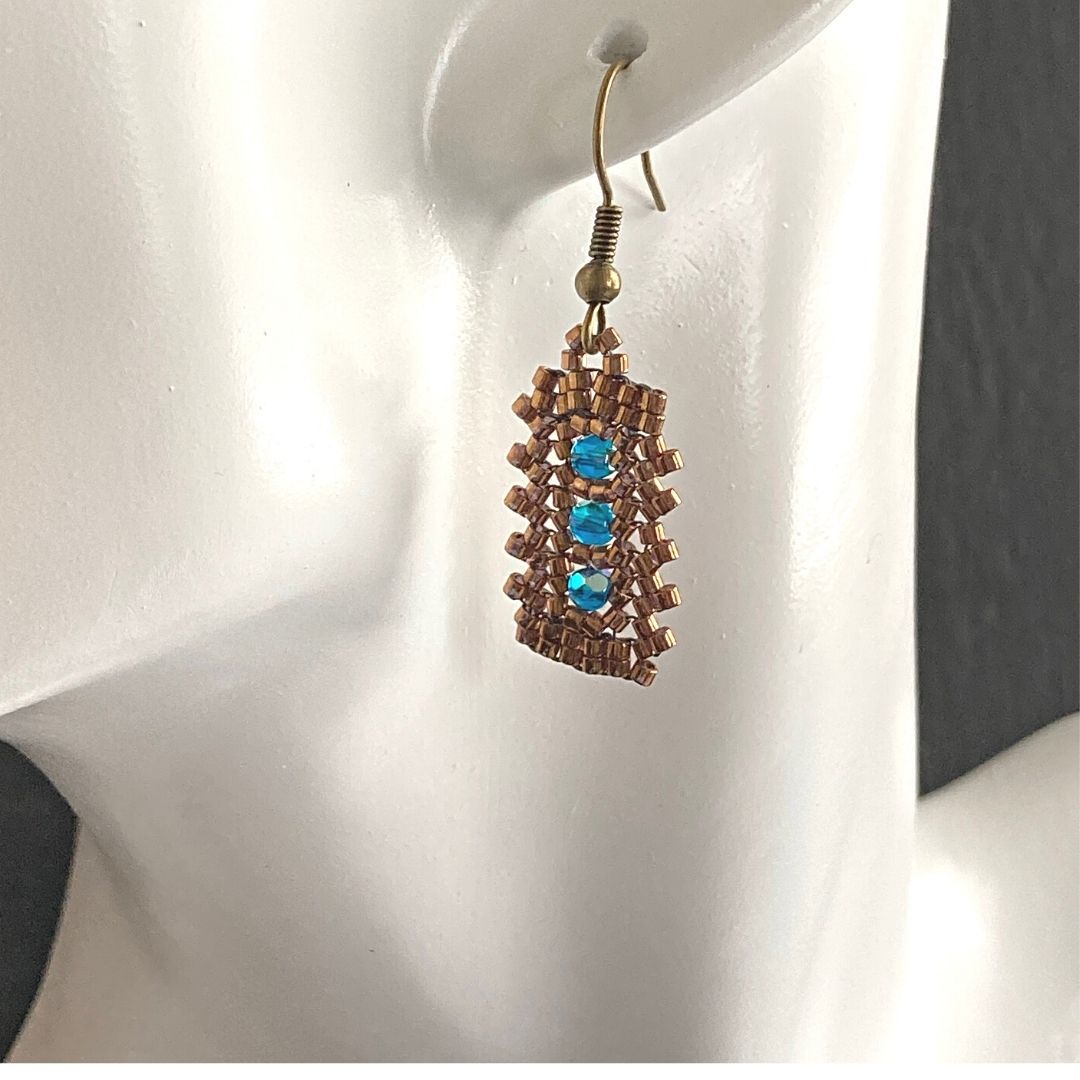 blue zircon crystal gold rectangle earring on a model