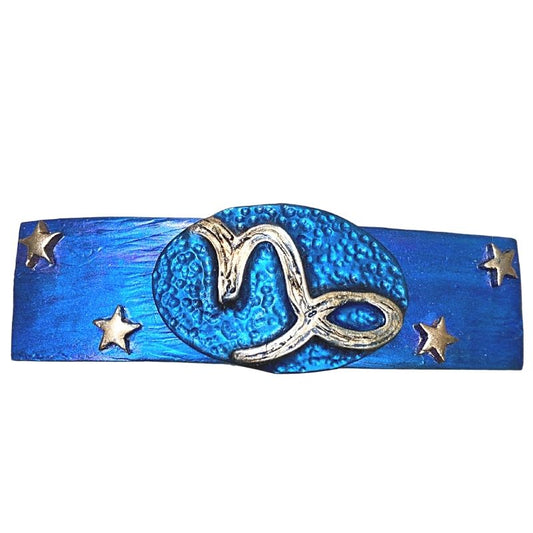 Capricorn zodiac sign hair clip with gold symbol and stars on blue and purple base