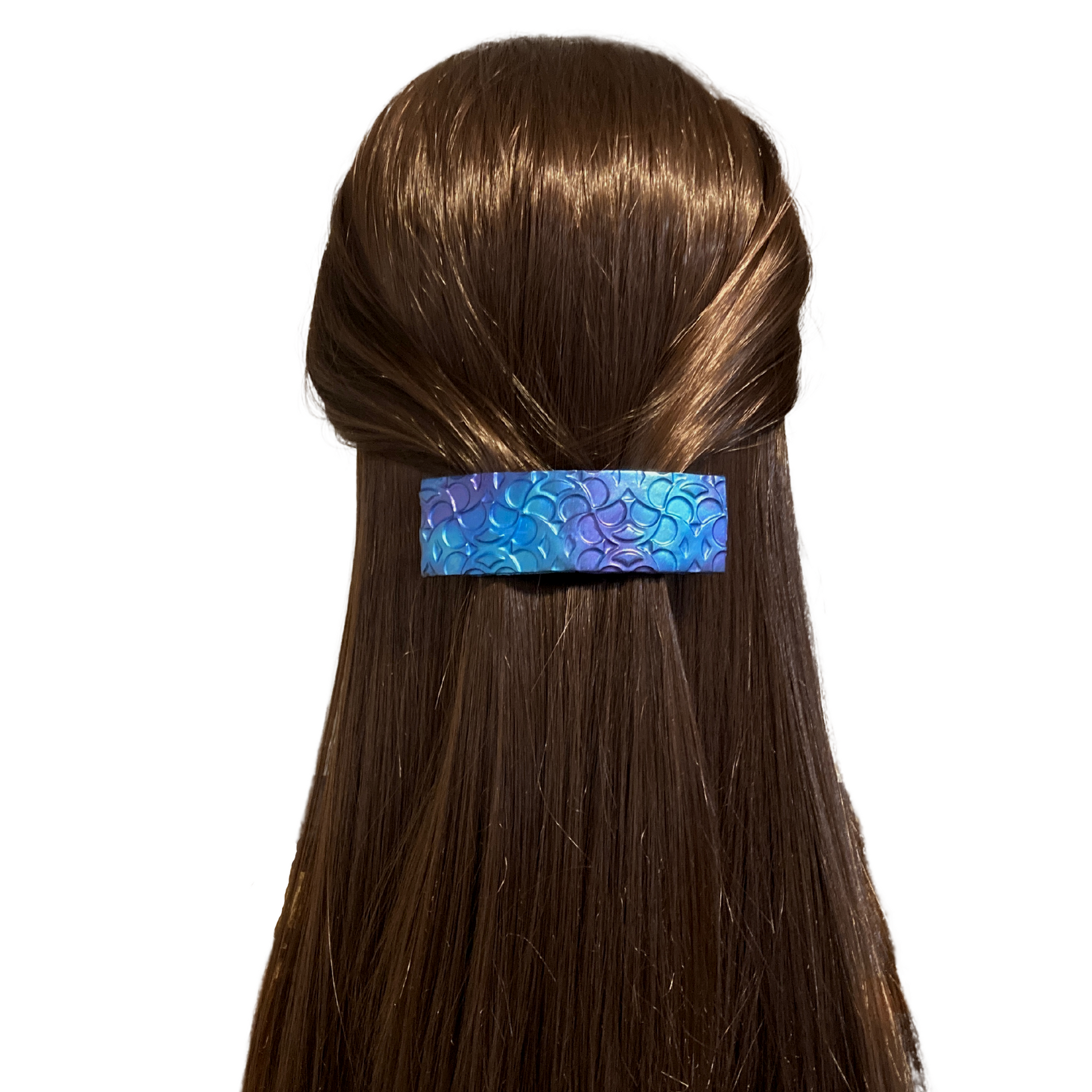 Dragon scale, hair barrette in  mermaid colors, blue purple, and green worn on a model.