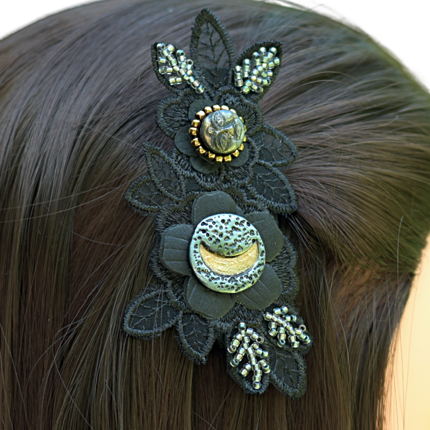Black applique flower beaded with silver and gold beads with a crescent moon and a full face moon focal cabochons in the hair of a model