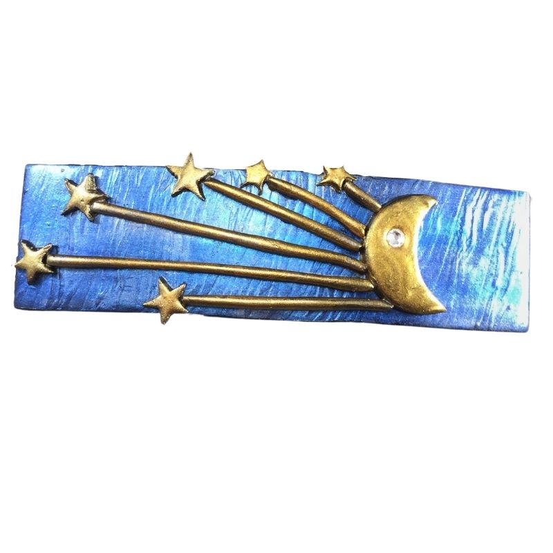 Blue hair barrette with gold crescent moon and starburst.