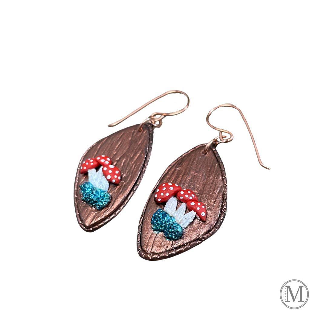 Geometric shaped bronze clay dangle earrings with small clusters of Amanita mushrooms