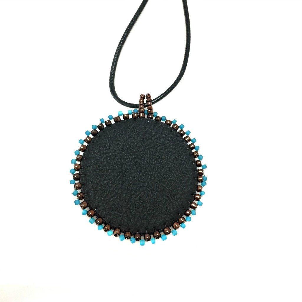 Back of Celtic necklace showing black faux suede and beaded edging