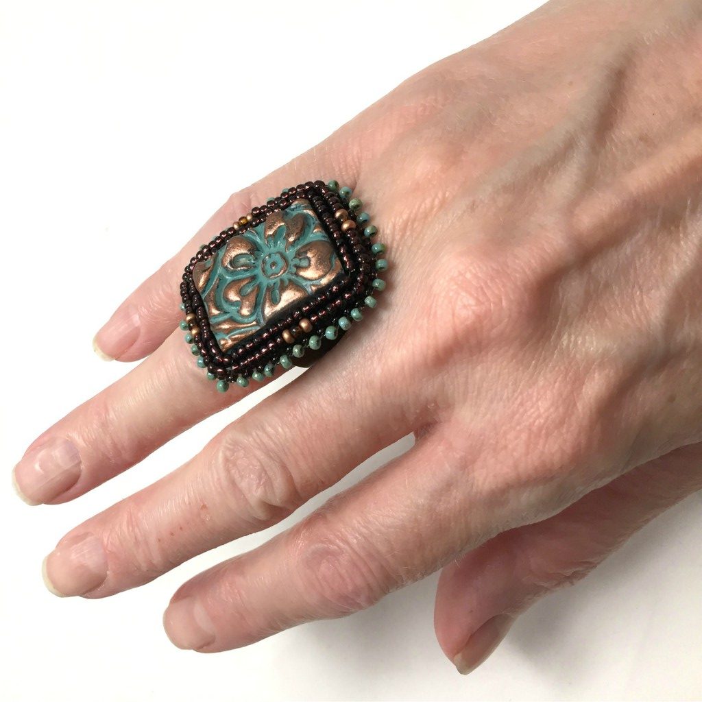 patina flower beaded cuff ring on hand
