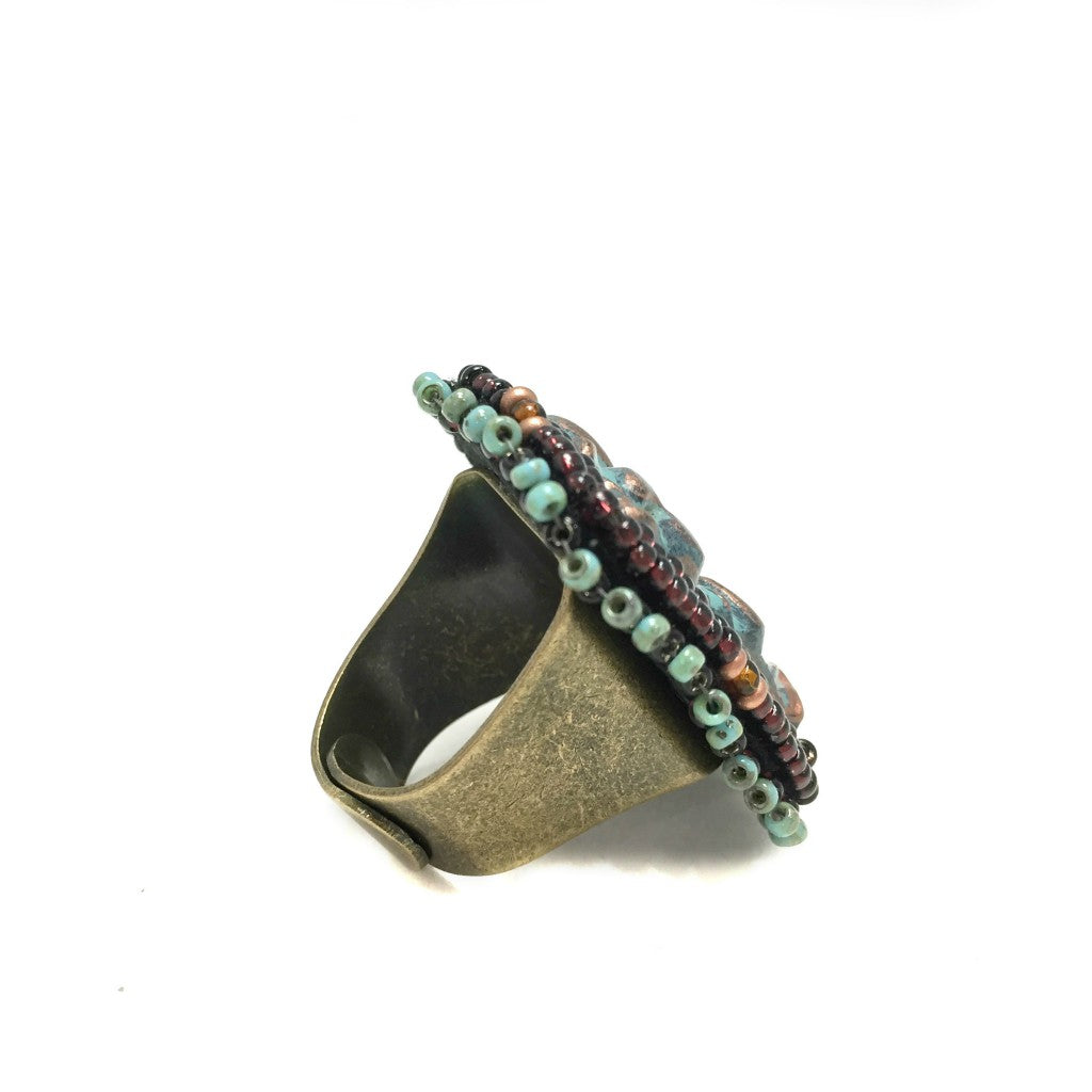 Sideview of textured patina copper and turquoise beaded flower ring
