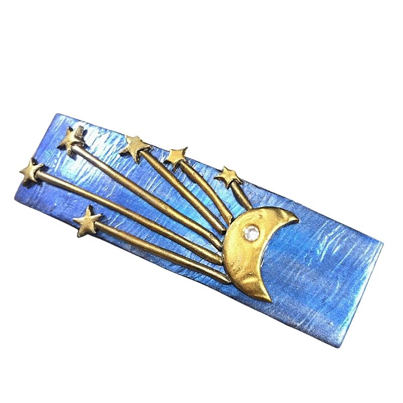 Blue hair barrette with gold crescent moon and shooting stars.