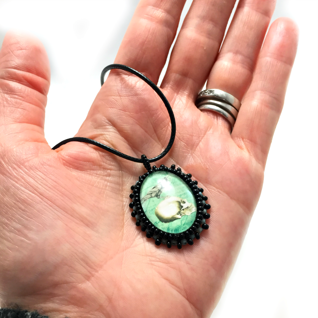 small turquoise skull hand