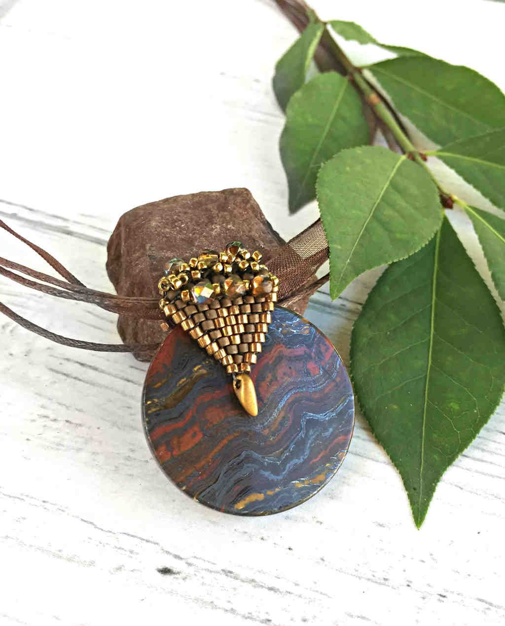 elegant tigers eye pendant with elaborate beaded gold bail