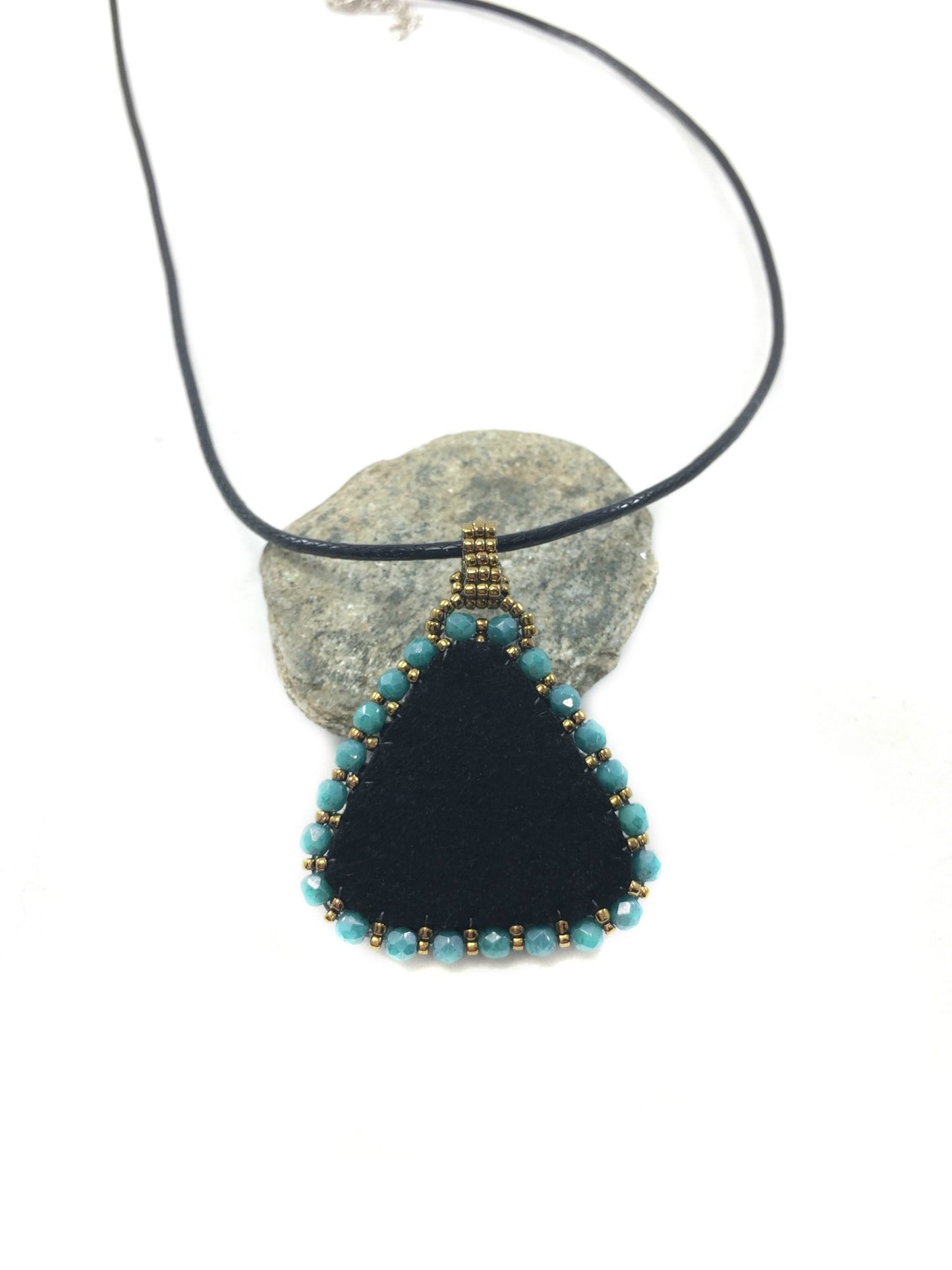 Back of Celtic Trinity necklace blue showing black, faux, suede, and turquoise crystal edging