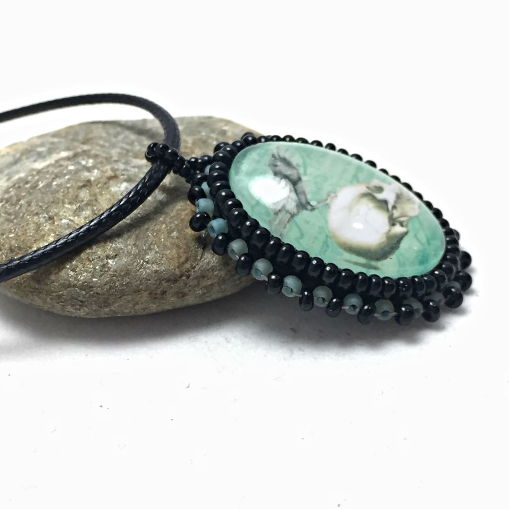 side shot of turquoise and Raven necklace