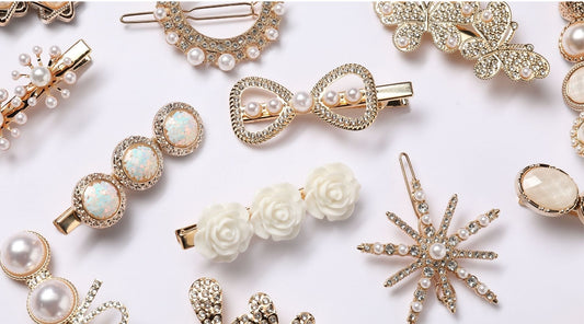 white and gold hair clips on a light pink background