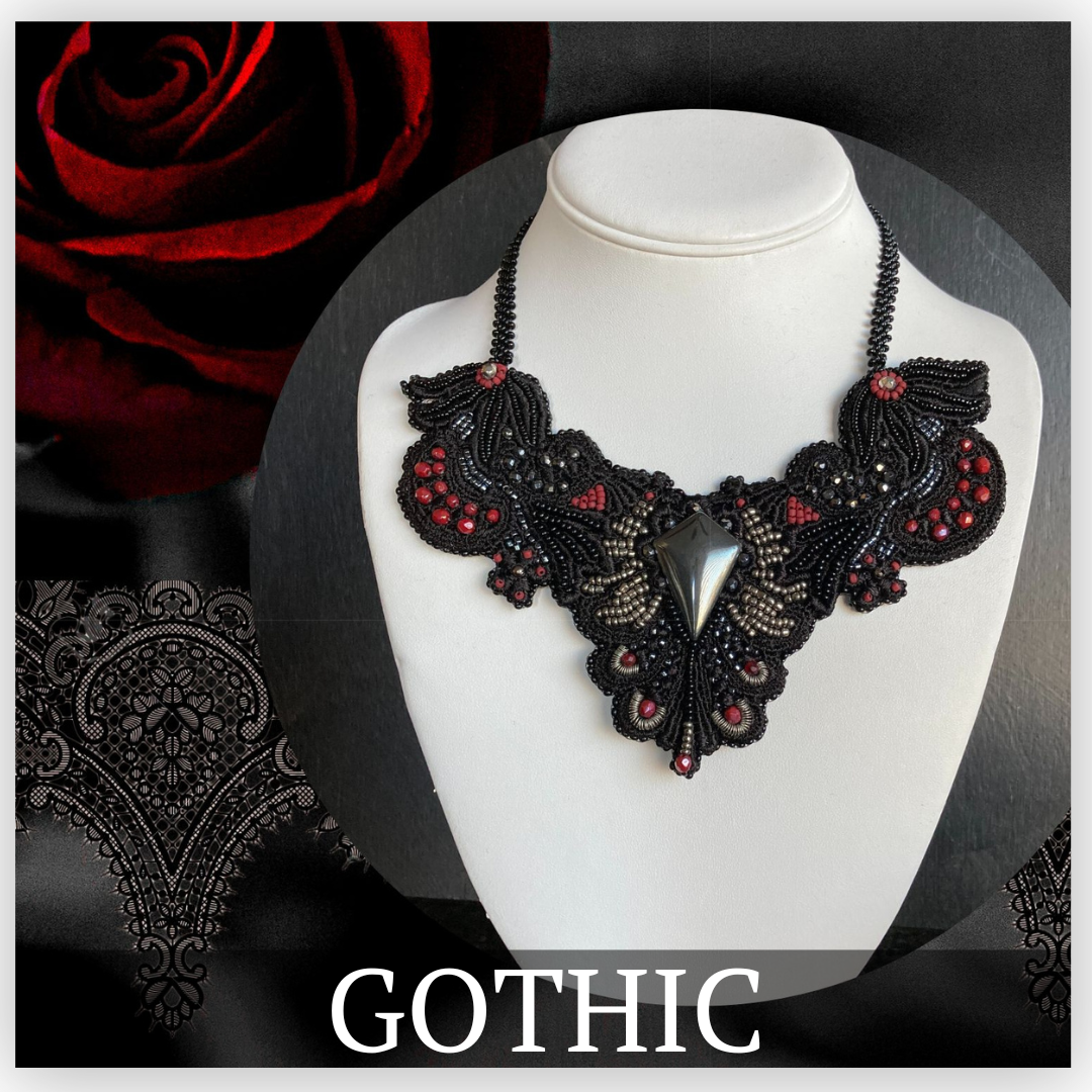 Black bib necklace with silver arrow center focal with black, silver and read bead embroidery.
