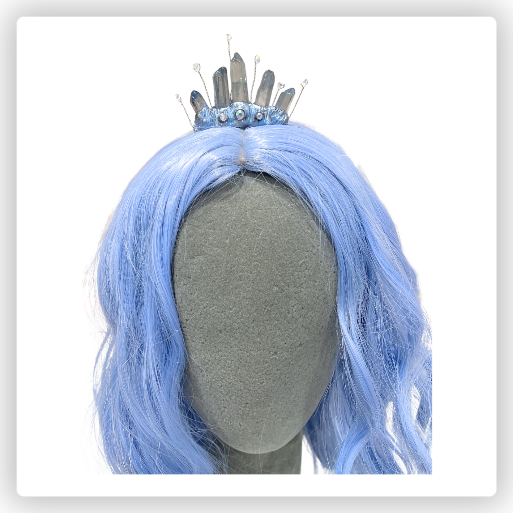 Copper wire forehead circlet with teardrop center crystal and clear crystals and blue ribbon cord.