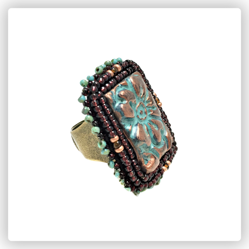 Abstract teardrop cuff ring with blue and gold seed beads, blue shibori silk and blue pearls.