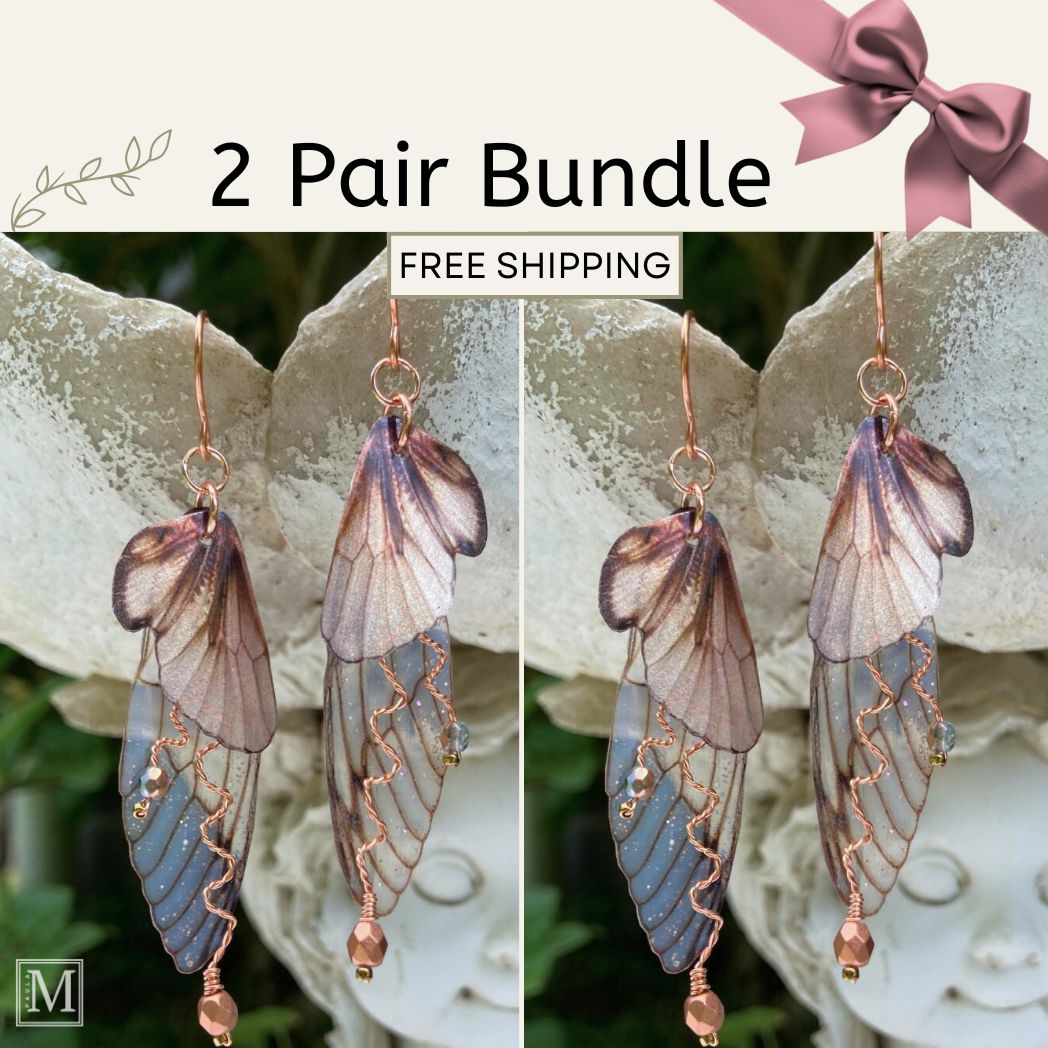 Pair of butterfly wing earrings with free shipping text on a decorative background