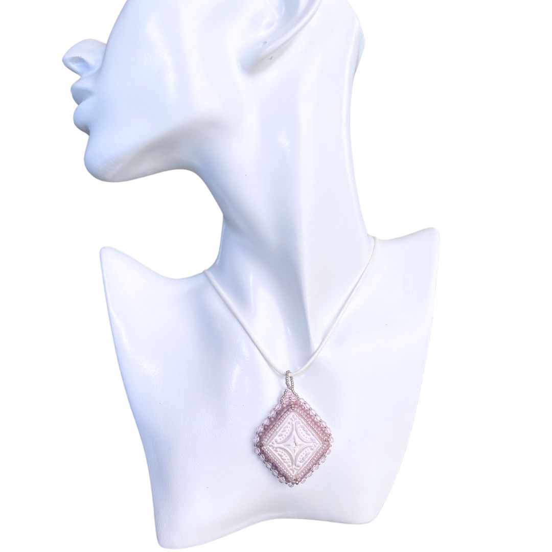 lilac beaded diamond shaped necklace on a model against a white background.