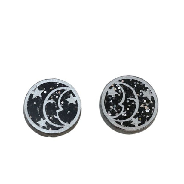 Black acrylic round earrings with silver glitter and silver moon motif.
