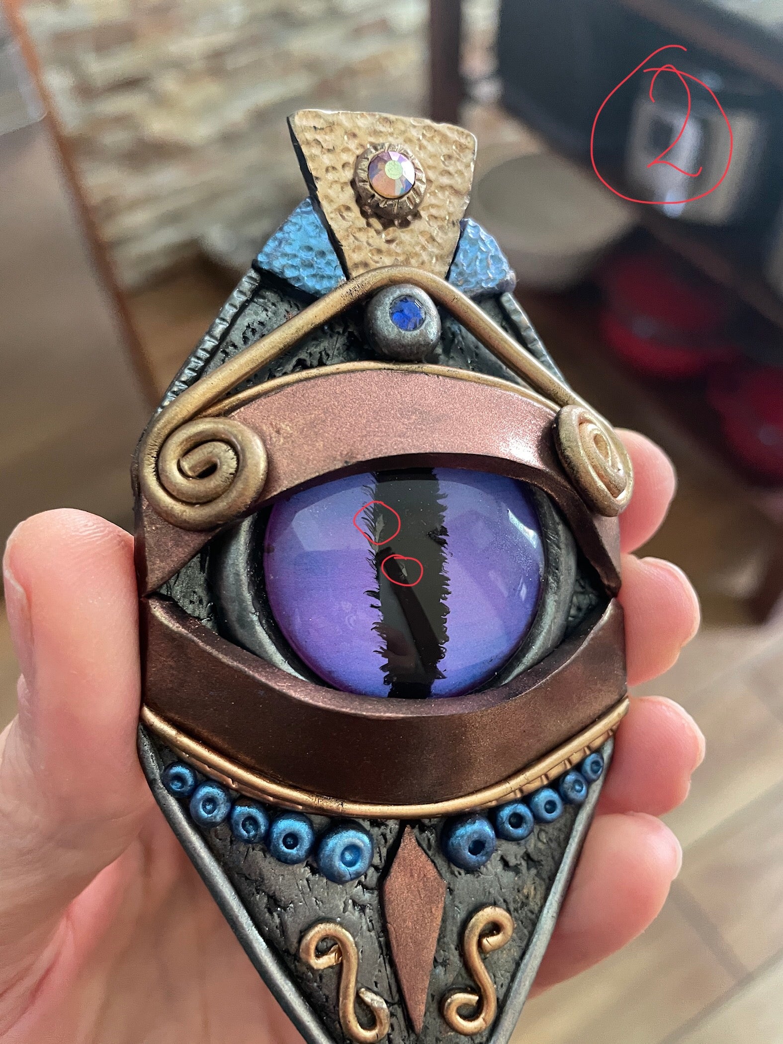 Dragon eye statement pendant necklace showing slight imperfections on the purple eye.