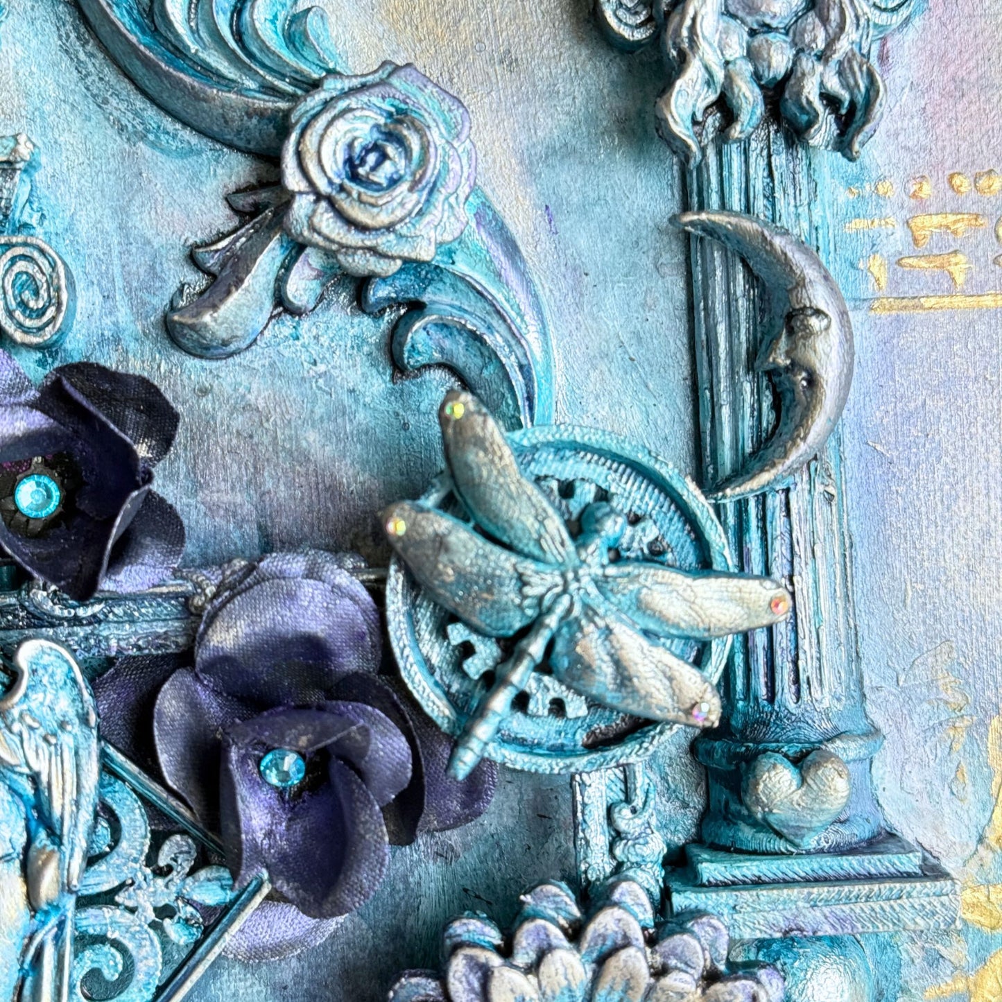 Decorative elements with flowers, dragonfly, and architectural details on a textured surface.