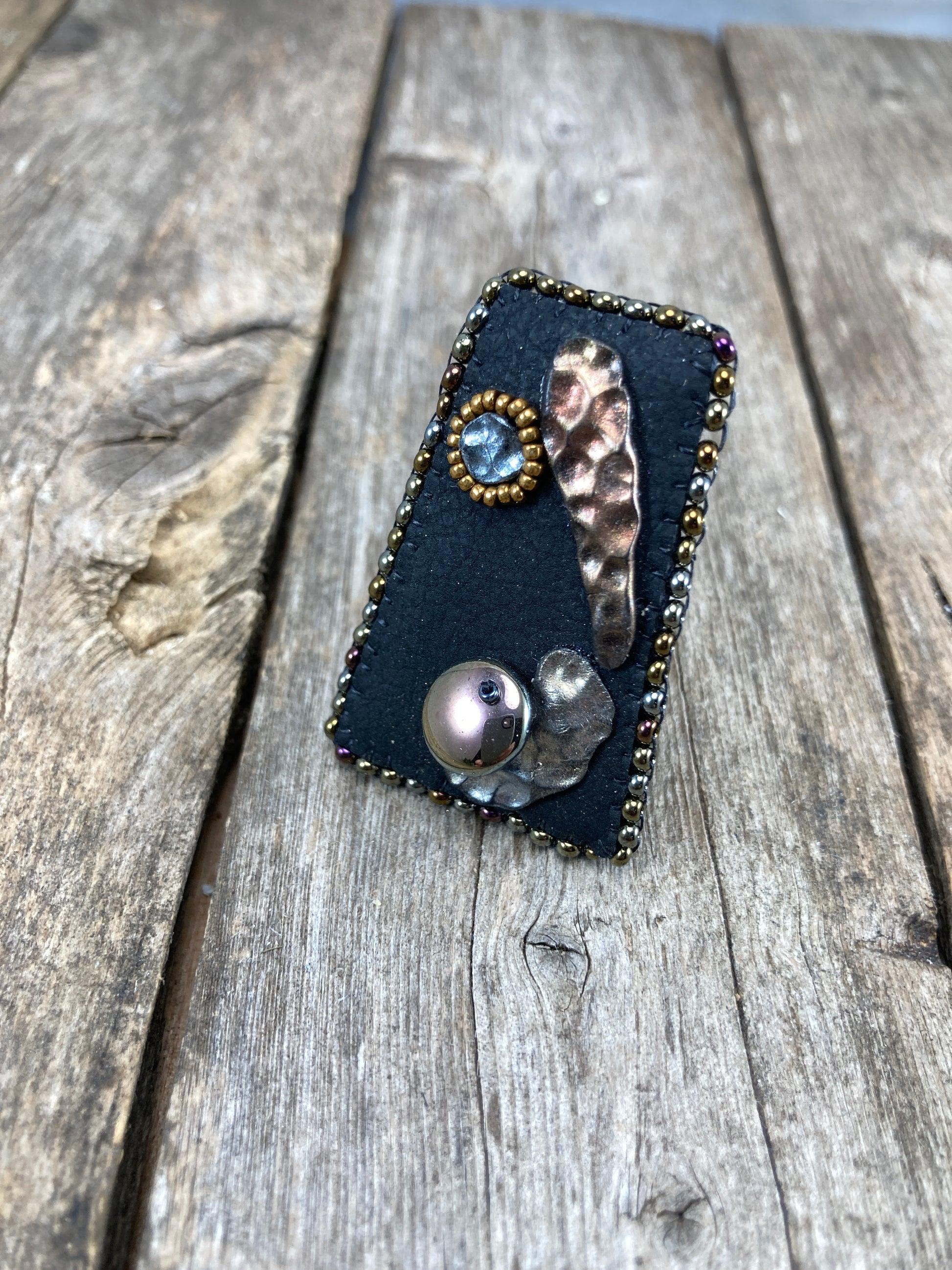 Geometric statement ring with abstract hammered copper and silver clay with dark gold beaded edge